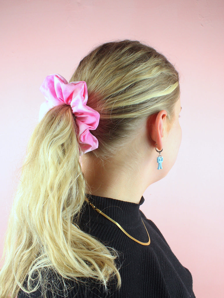 Model wearing a pink and tie dye scrunchie