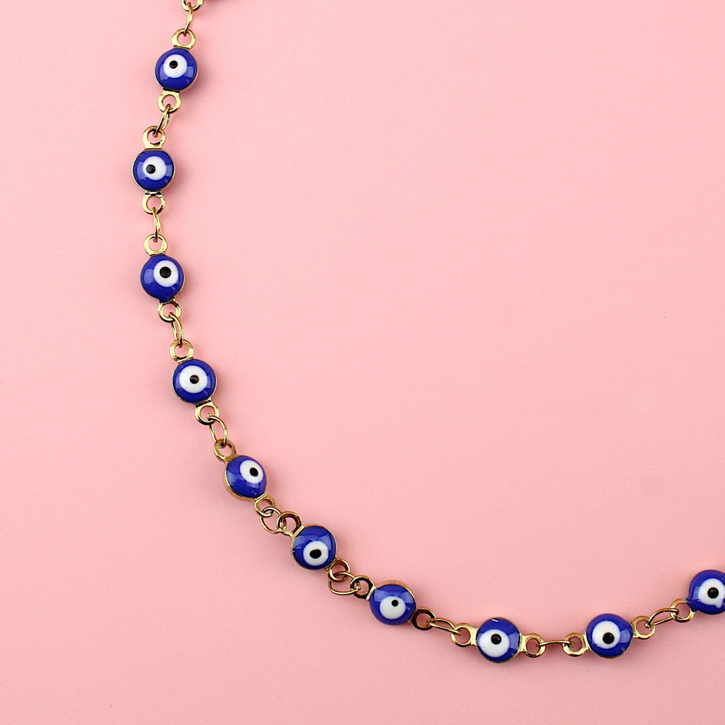 Dark blue evil eye charms on a gold plated stainless steel anklet