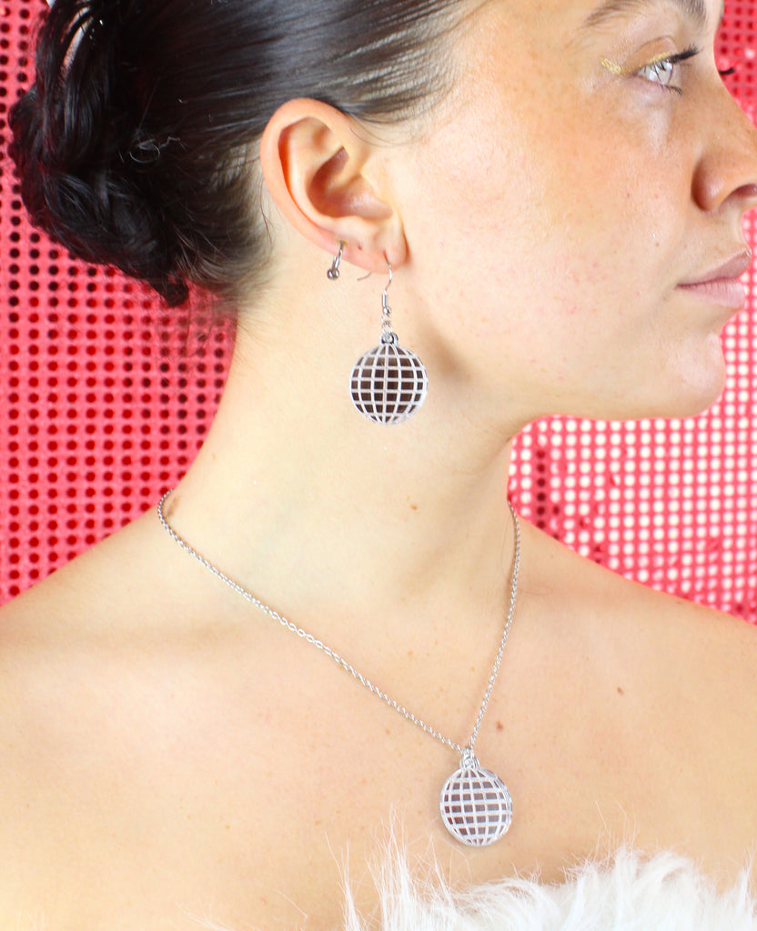 Model wearing disco ball earrings with matching necklace