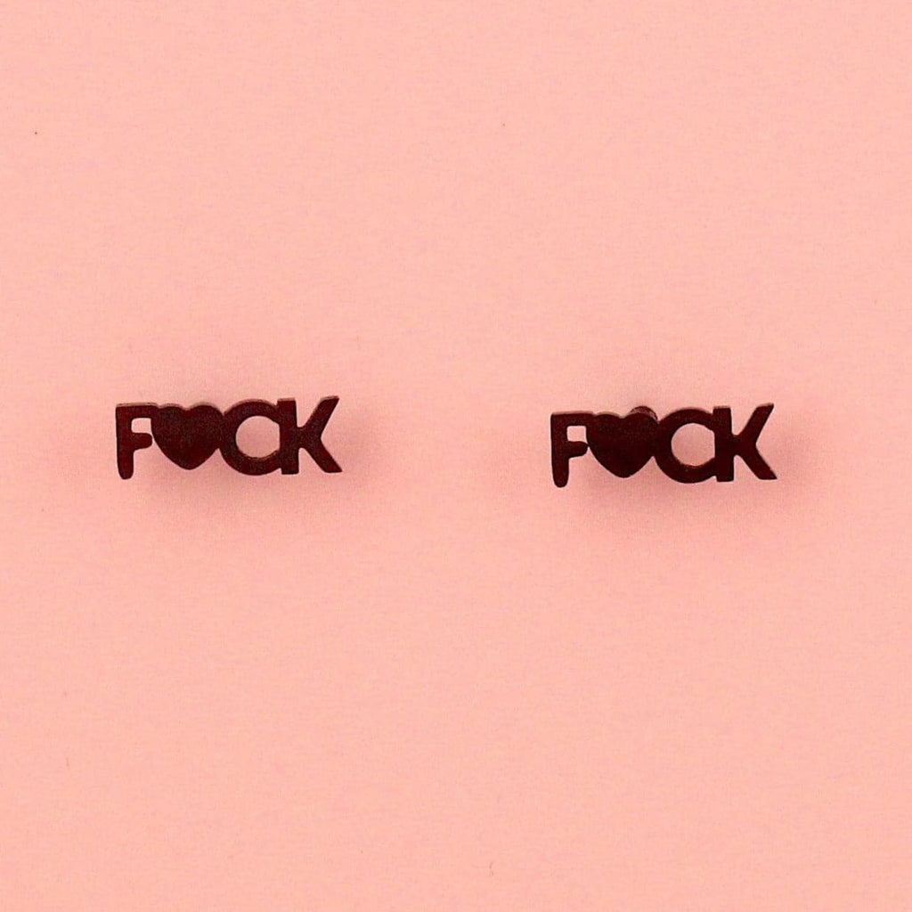 Black stud earrings with the word F*CK, the U being replaced with a heart