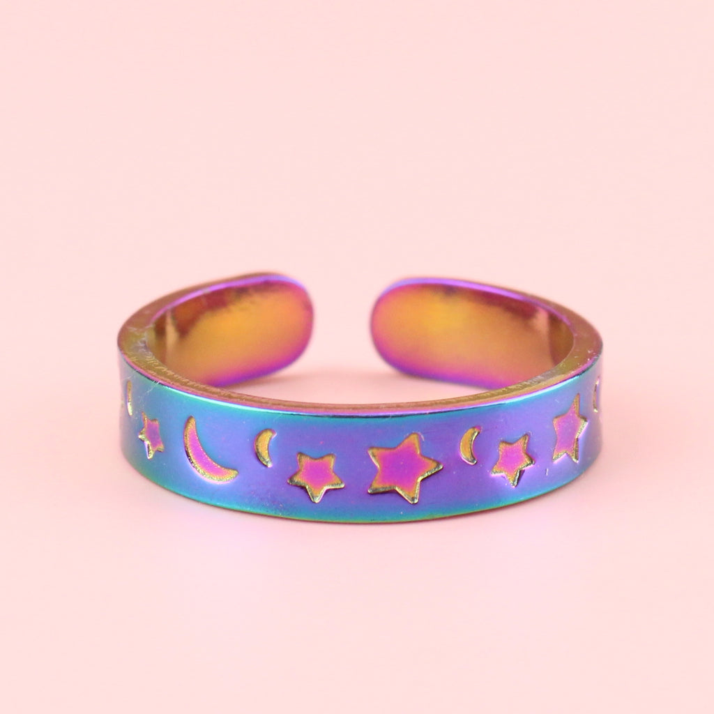 Rainbow-tinted stainless steel ring with moons and stars engraved on the band