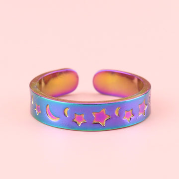 Rainbow-tinted stainless steel ring with moons and stars engraved on the band