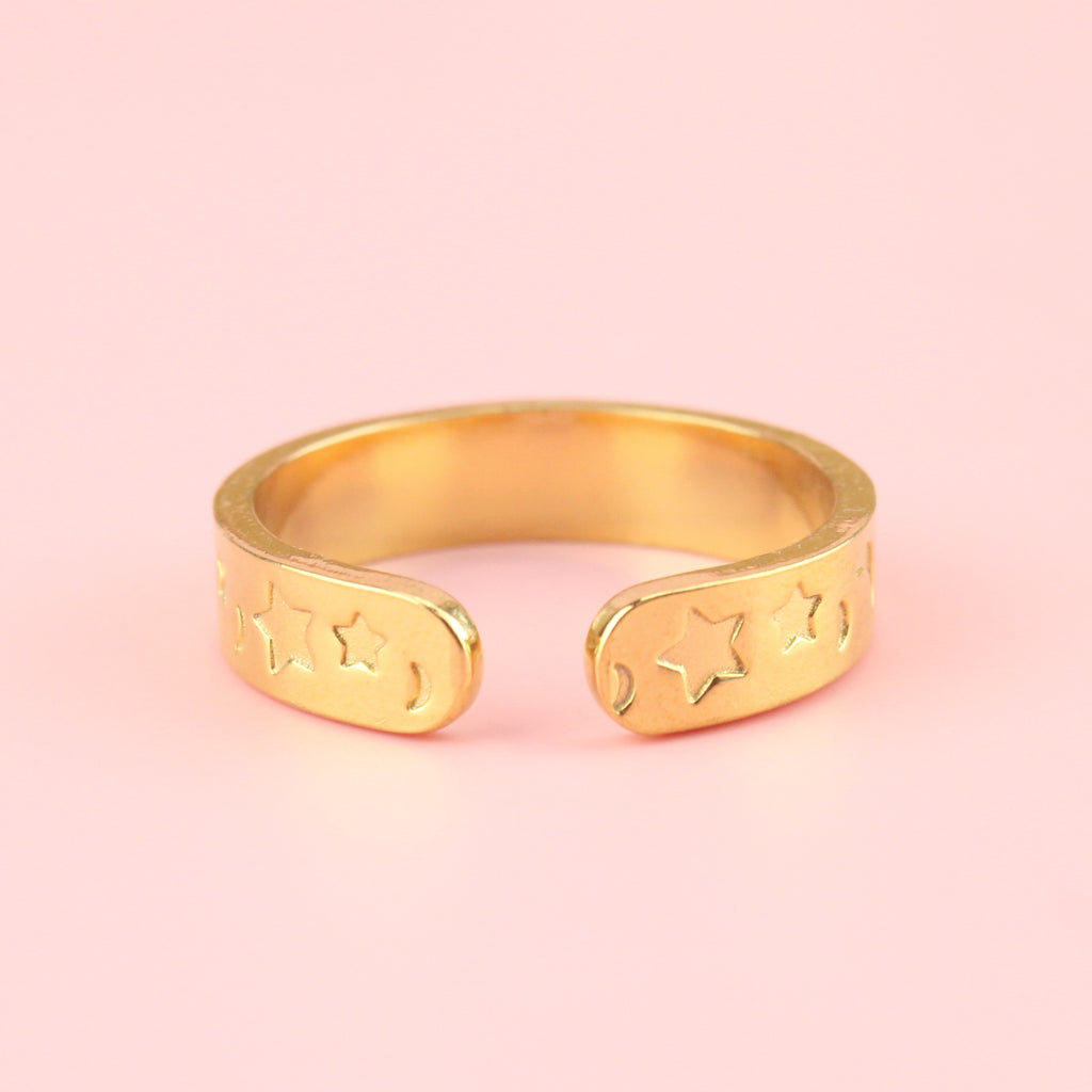 Gold plated stainless steel ring with moons and stars engraved on the band