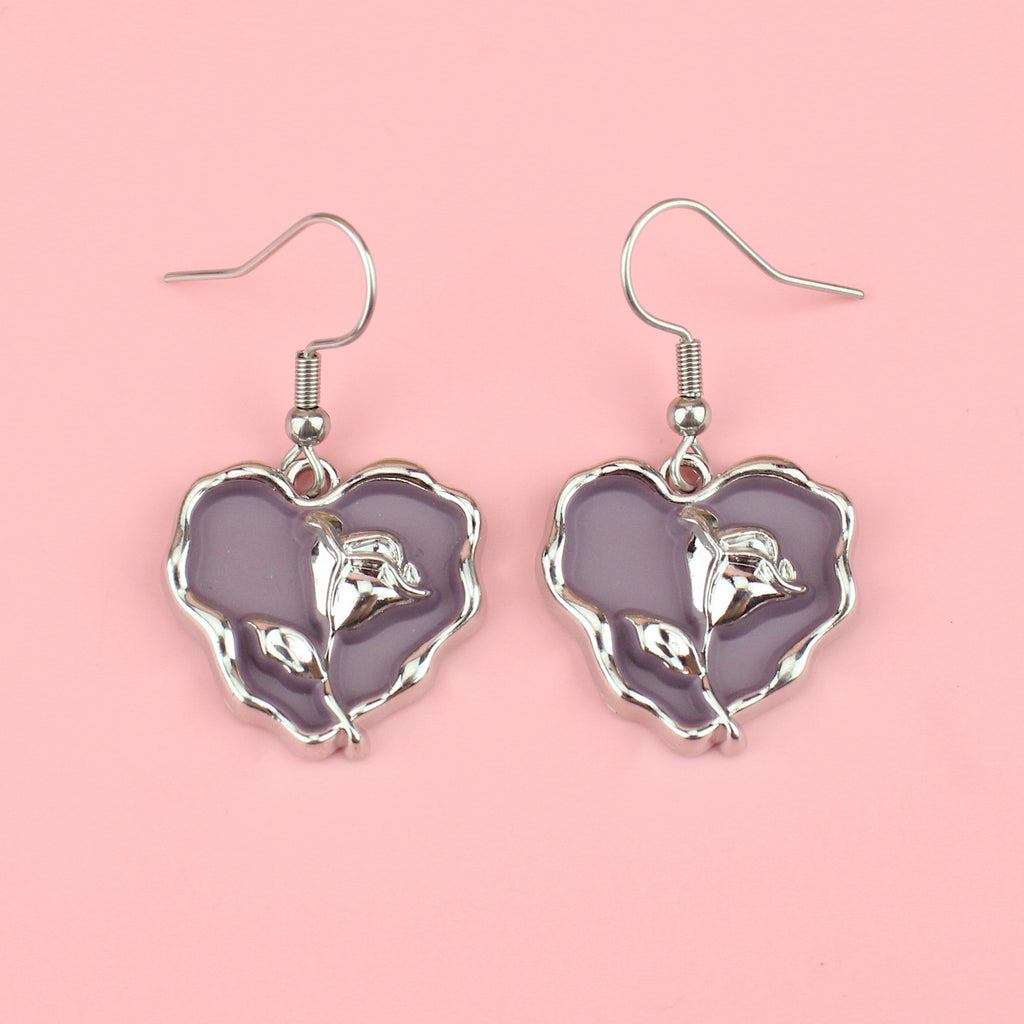 a base metal charm with a beautiful rose in the centre of a purple heart, suspended from sleek stainless steel ear wires
