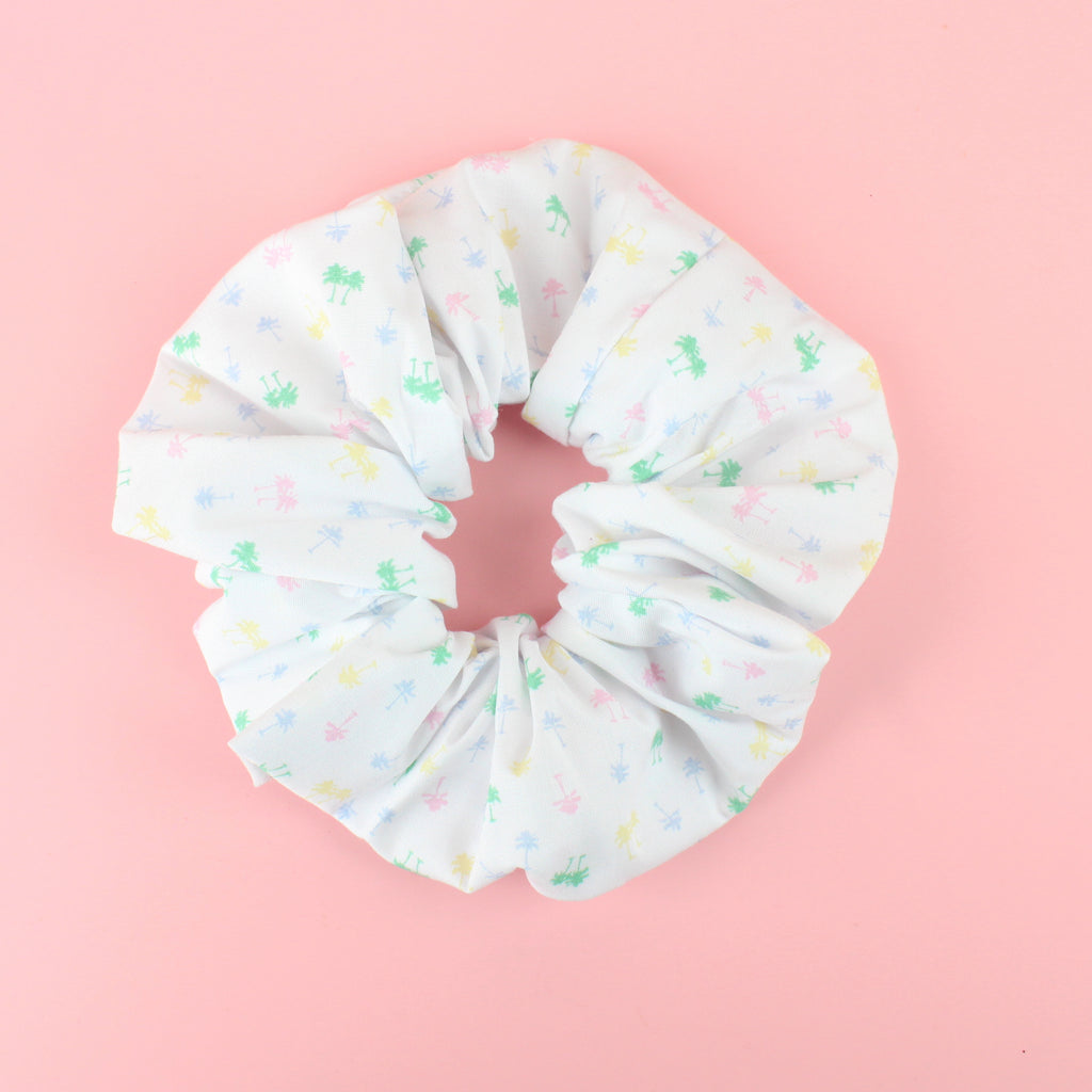 White scrunchie with green, yellow, blue and pink palm trees palm tree print