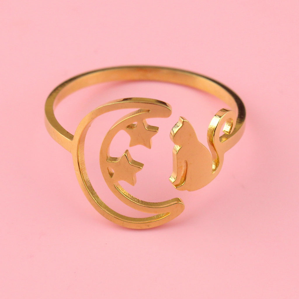 Gold plated stainless steel ring with a crescent moon on the left with 2 stars and a cat facing the moon on the right