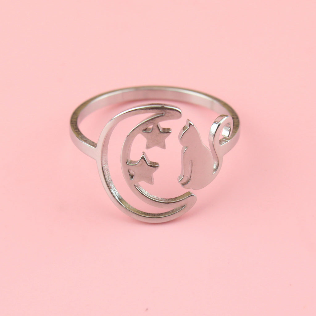 stainless steel ring with a crescent moon on the left with 2 stars and a cat facing the moon on the right