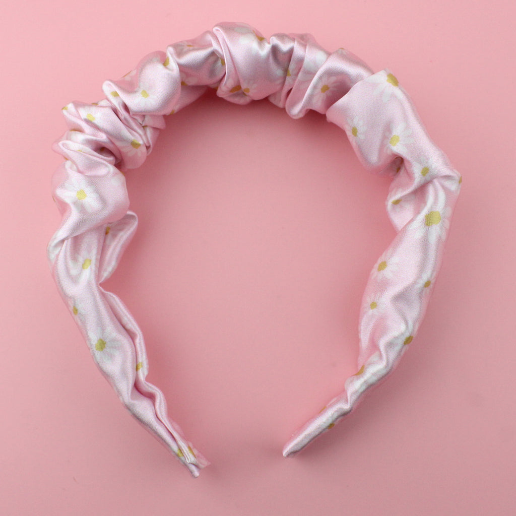 Pastel pink scrunchie style headband with a daisy design