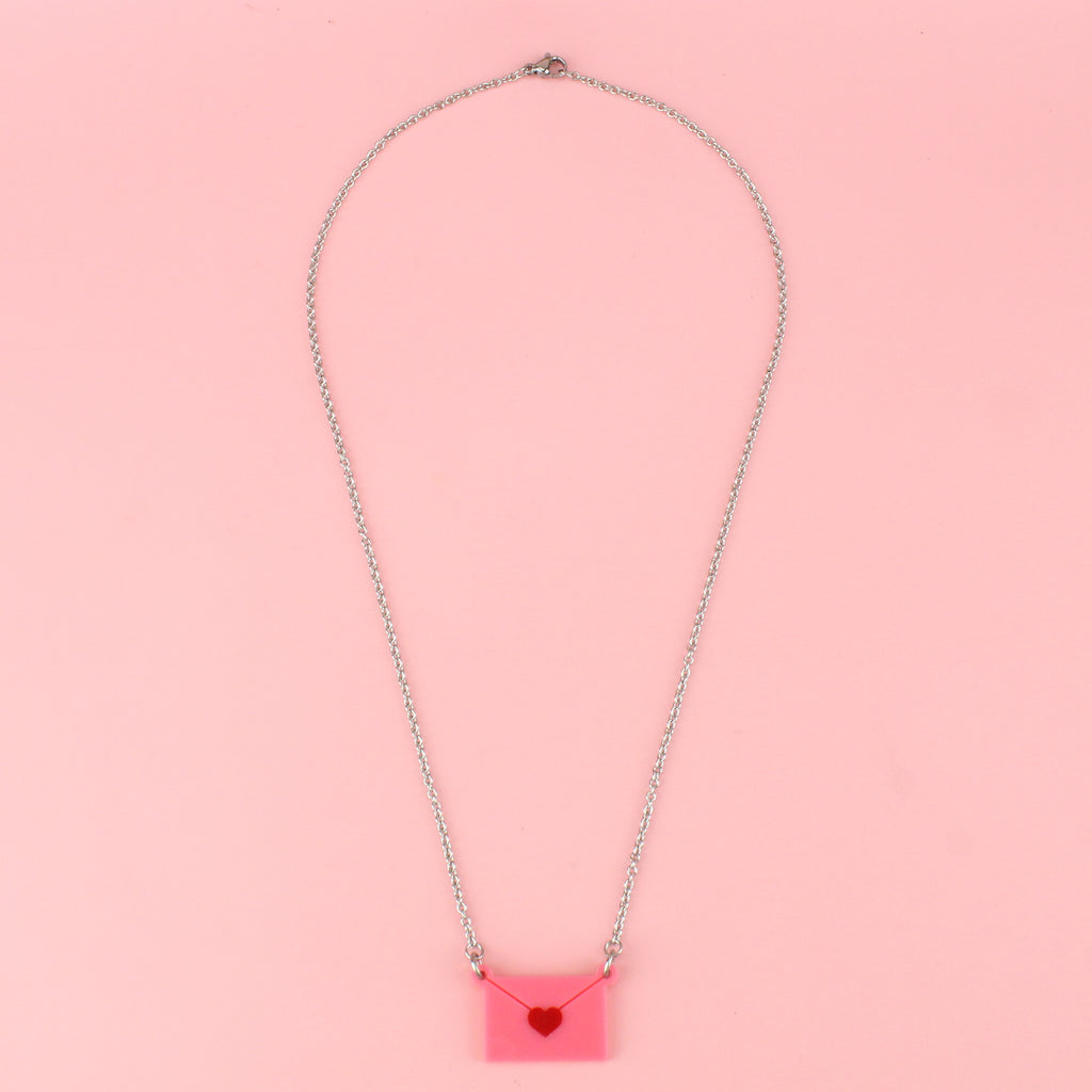pink envelope pendant sealed with a red heart on a stainless steel chain