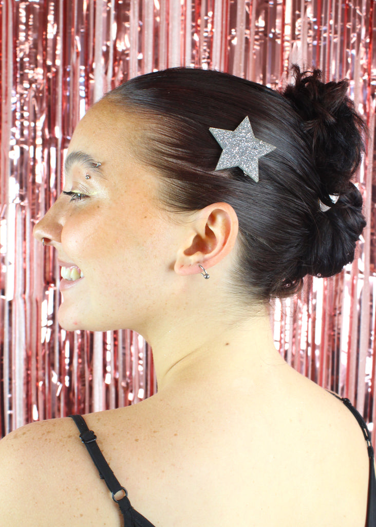 Model wearing large silver glittery star hair clip