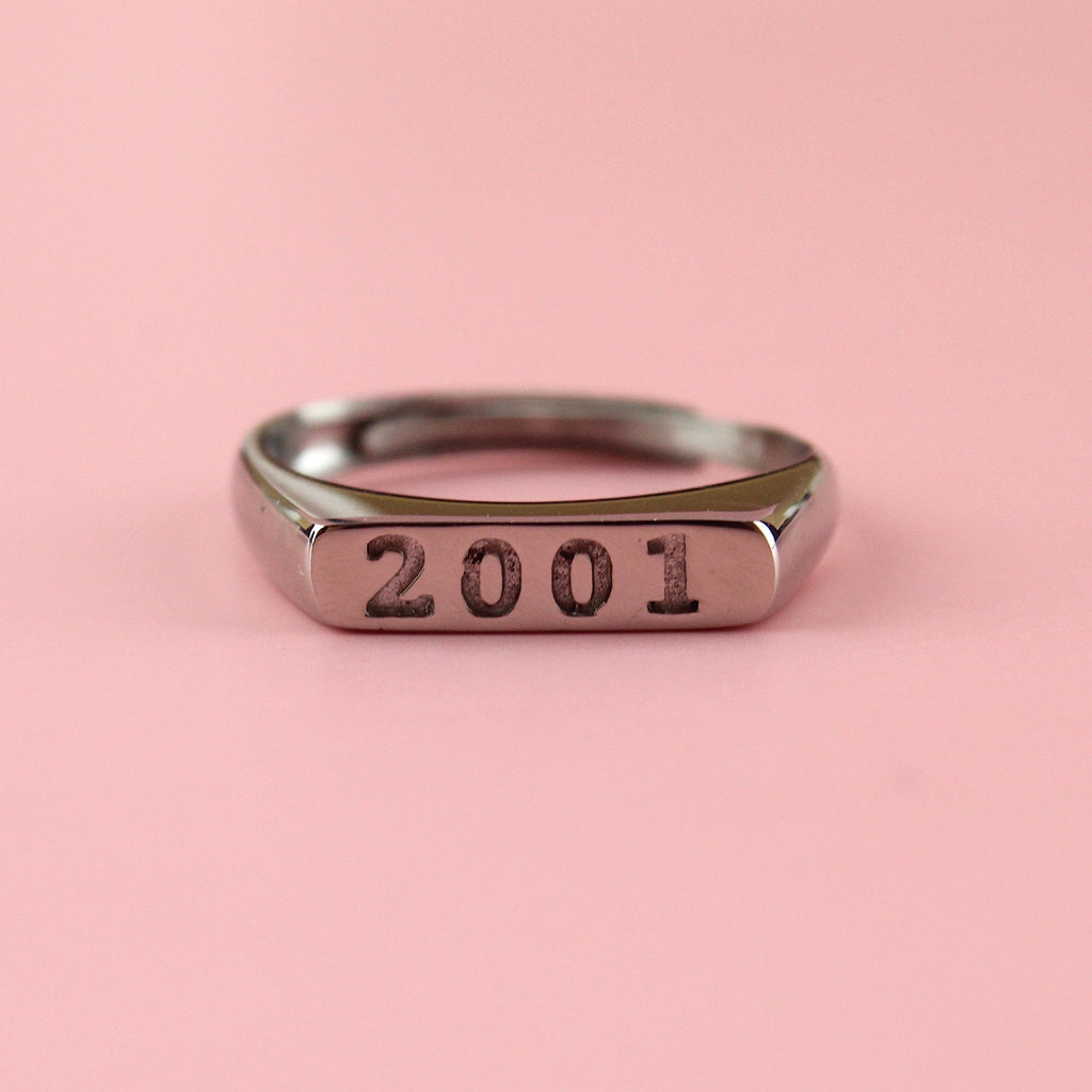 Stainless steel ring with 2001 engraved on the front