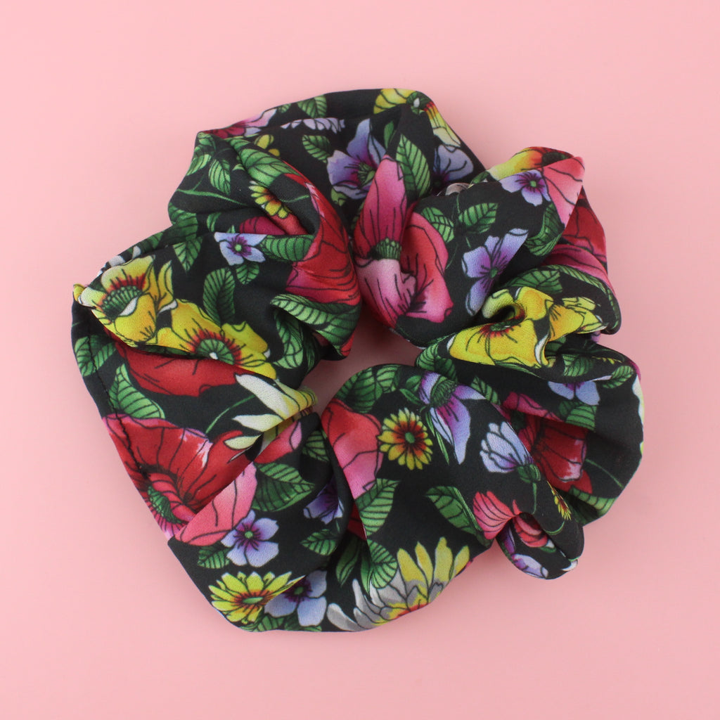 Dark Green Scrucnhie with a floral pattern featuring red, pink, yellow and lilac flowers and green leaves