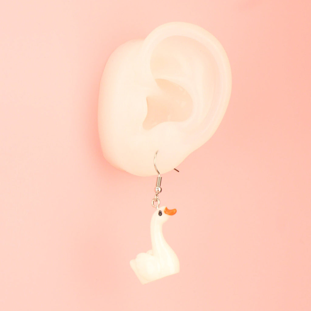 Ear wearing the Swan-derful Earrings