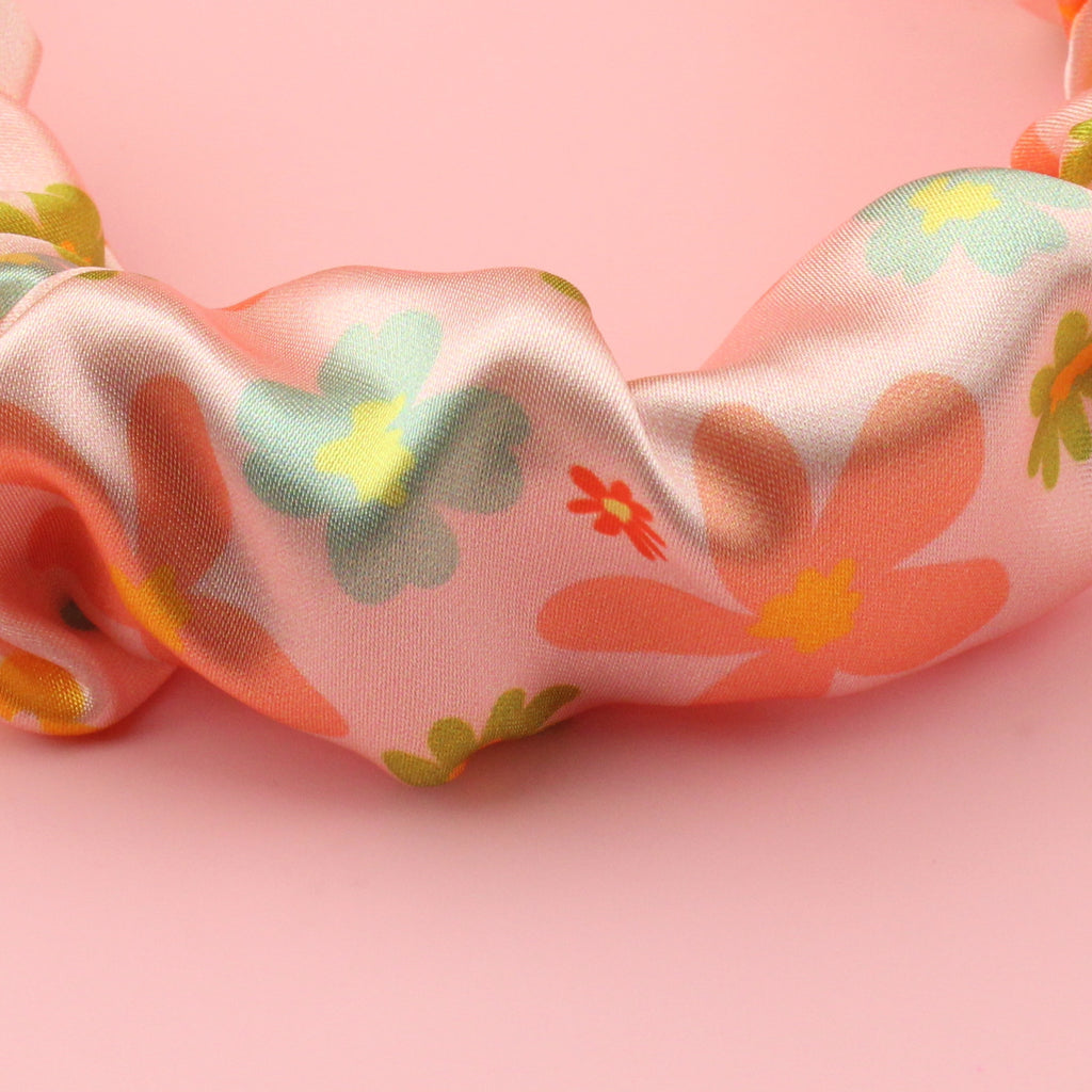Satin scrunchie style headband with a pink floral design
