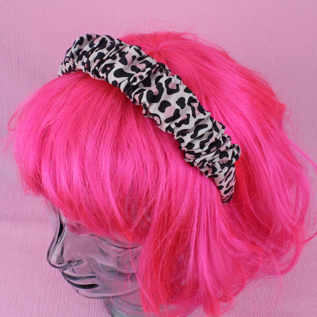 Pink leopard print scrunchie style headband shown on a wig for scale
