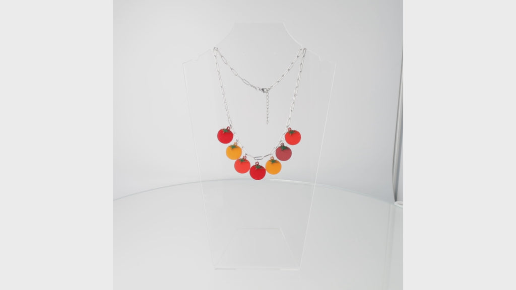 360 view of stainless steel oval link necklace featuring seven red and orange tomato pendants