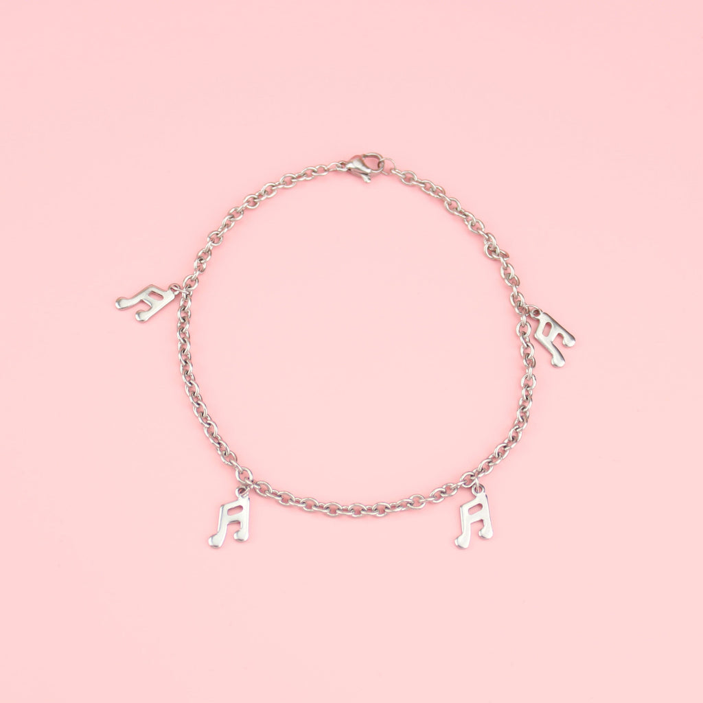 Stainless Steel bracelet featuring charms with music notes on them