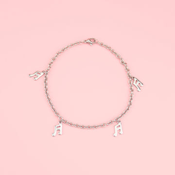 Stainless Steel bracelet featuring charms with music notes on them