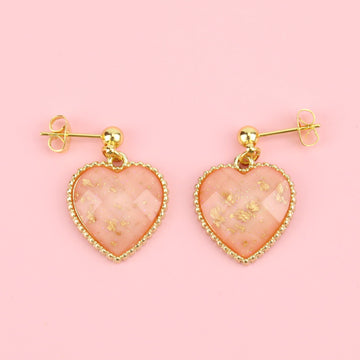 Faceted pink heart charms with gold dust decoration on gold plated stainless steel studs