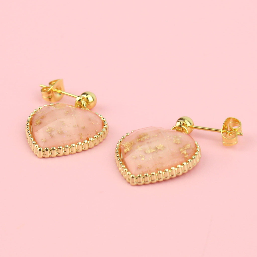 Faceted pink heart charms with gold dust decoration on gold plated stainless steel studs
