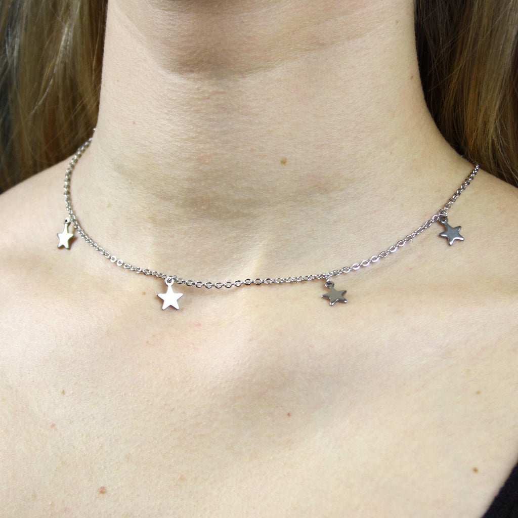 Model wearing stainless steel choker with stainless star charms