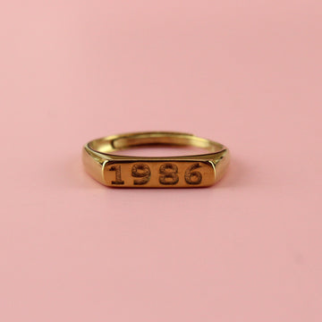 Gold plated stainless steel ring with 1986 engraved on the front