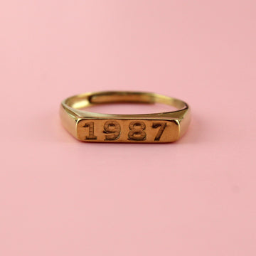 Gold plated stainless steel ring with 1987 engraved on the front