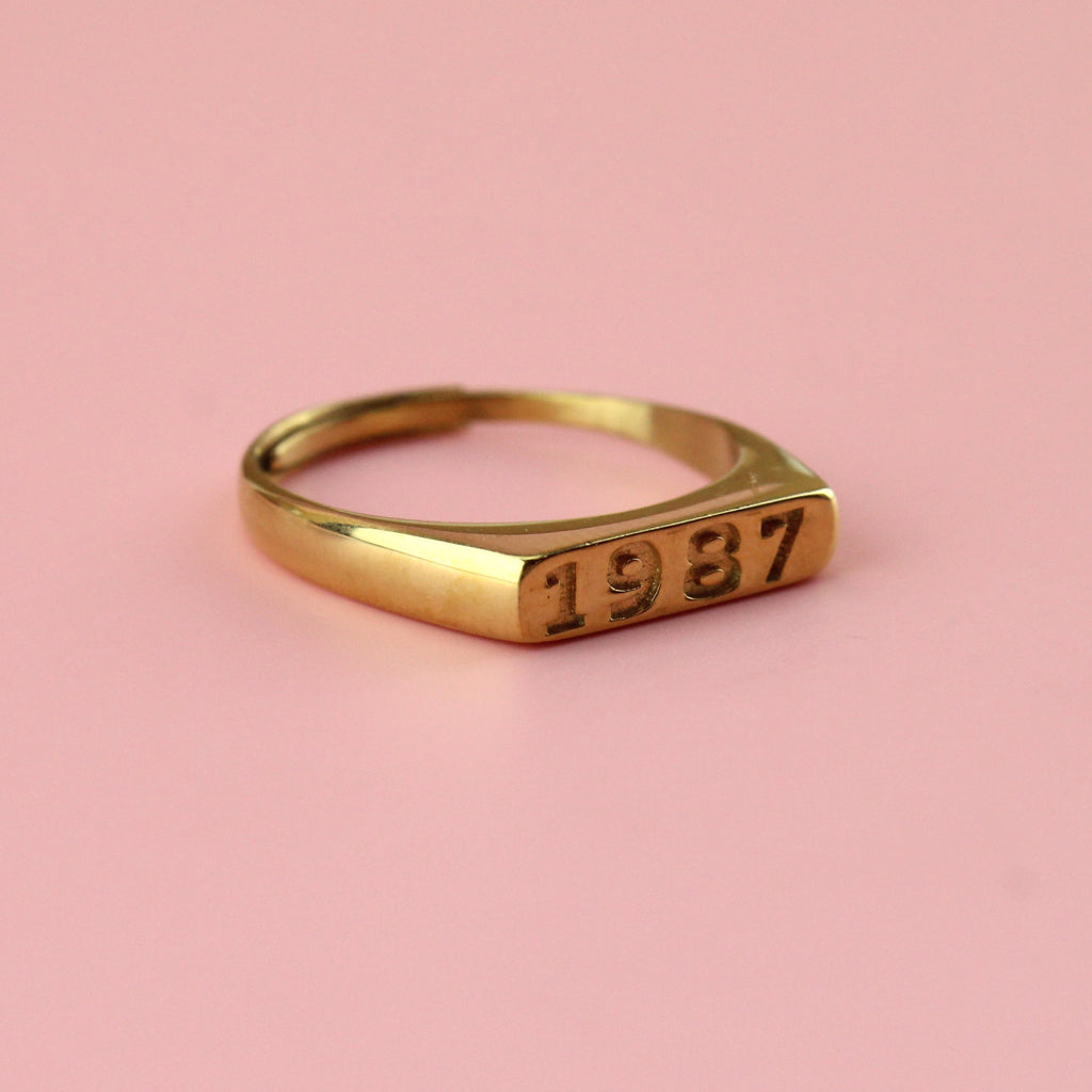 Gold plated stainless steel ring with 1987 engraved on the front