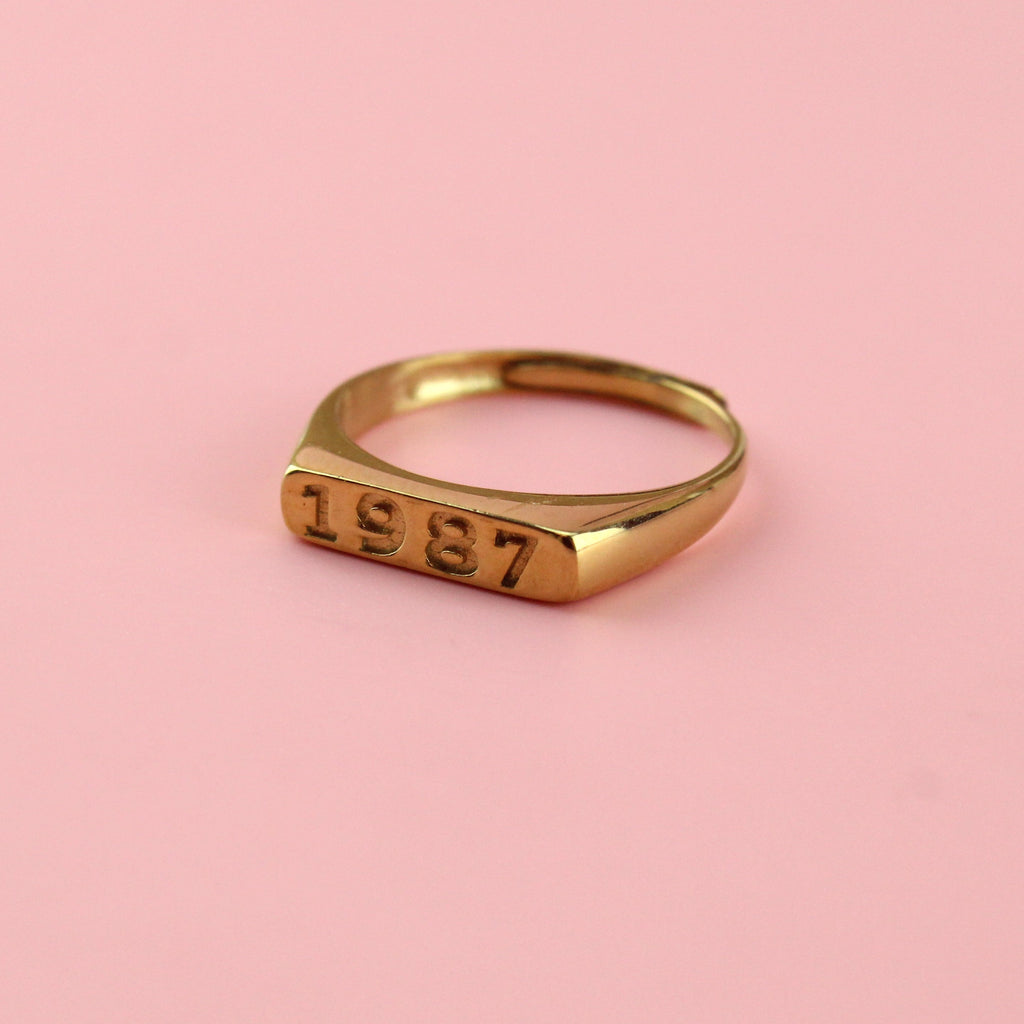 Gold plated stainless steel ring with 1987 engraved on the front