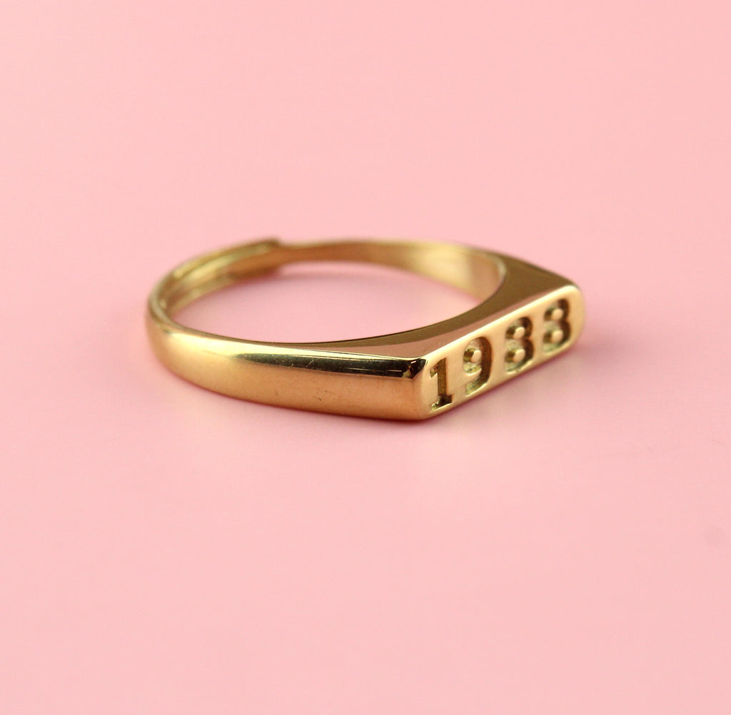 Gold plated stainless steel ring with 1989 engraved on the front