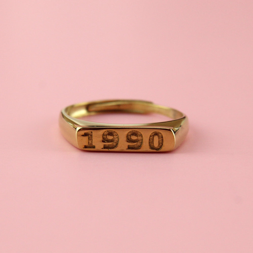 Gold plated stainless steel ring with 1990 engraved on the front