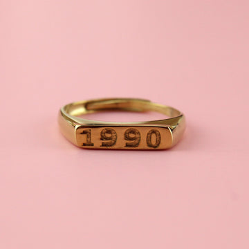 Gold plated stainless steel ring with 1990 engraved on the front