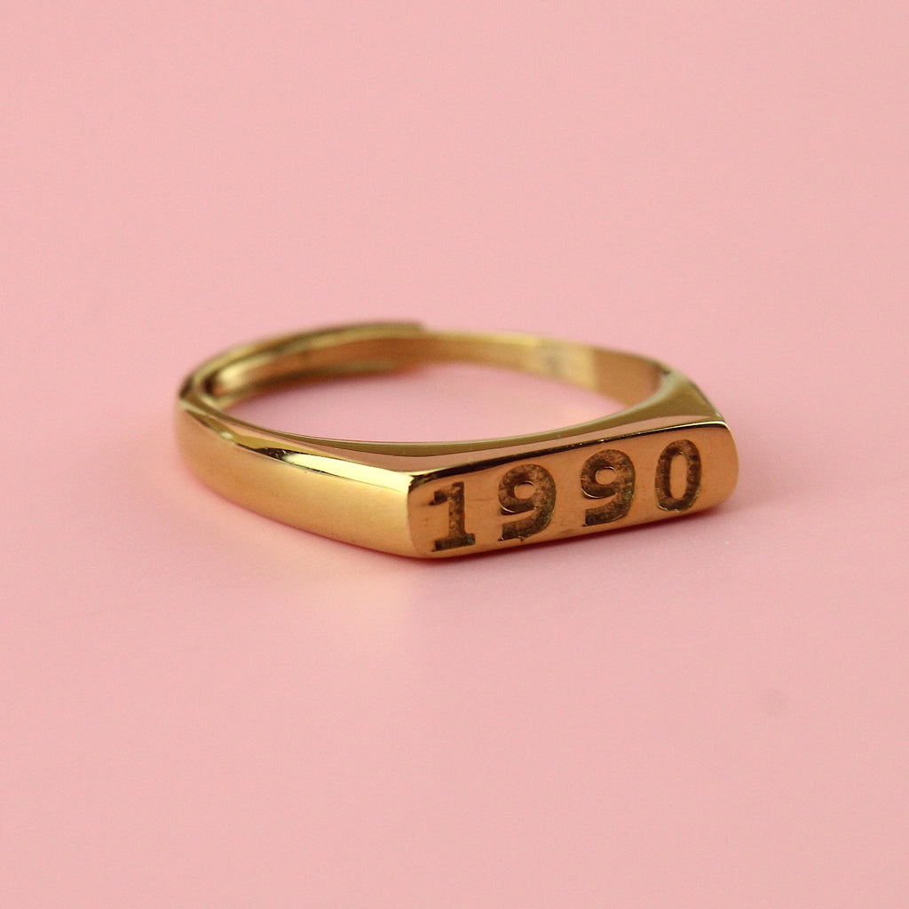 Gold plated stainless steel ring with 1990 engraved on the front