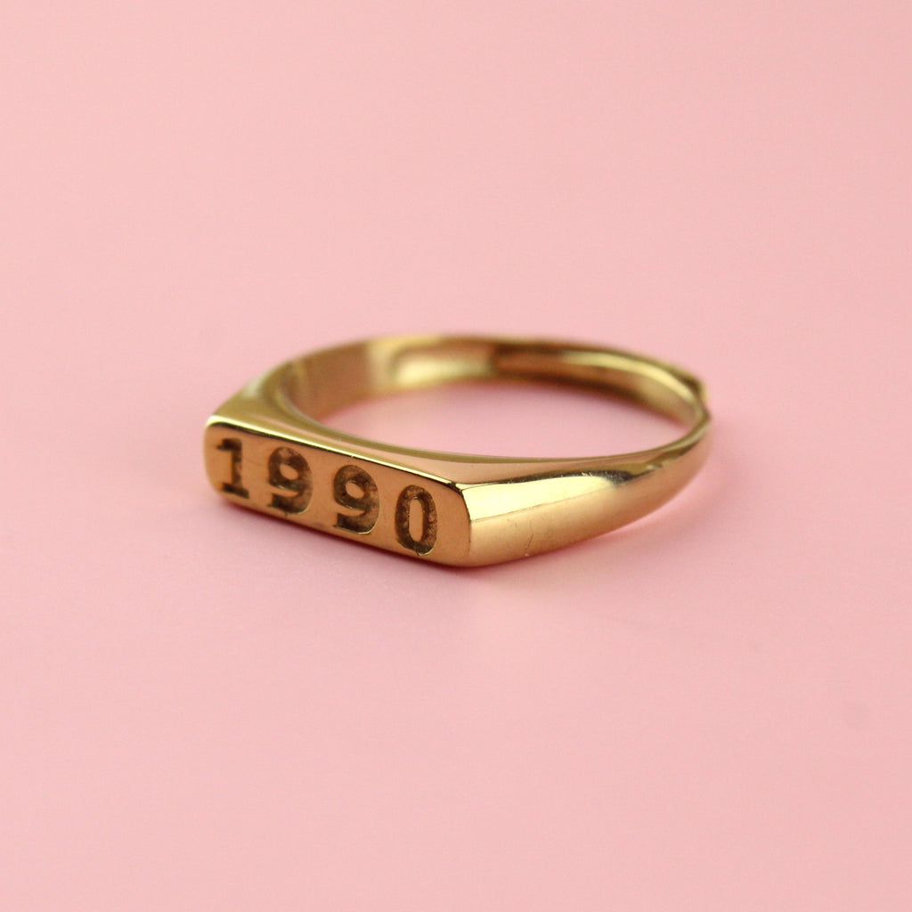 Gold plated stainless steel ring with 1990 engraved on the front