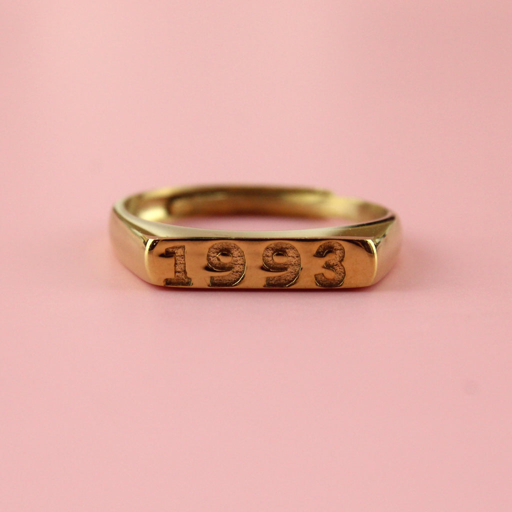 Gold plated stainless steel ring with 1993 engraved on the front