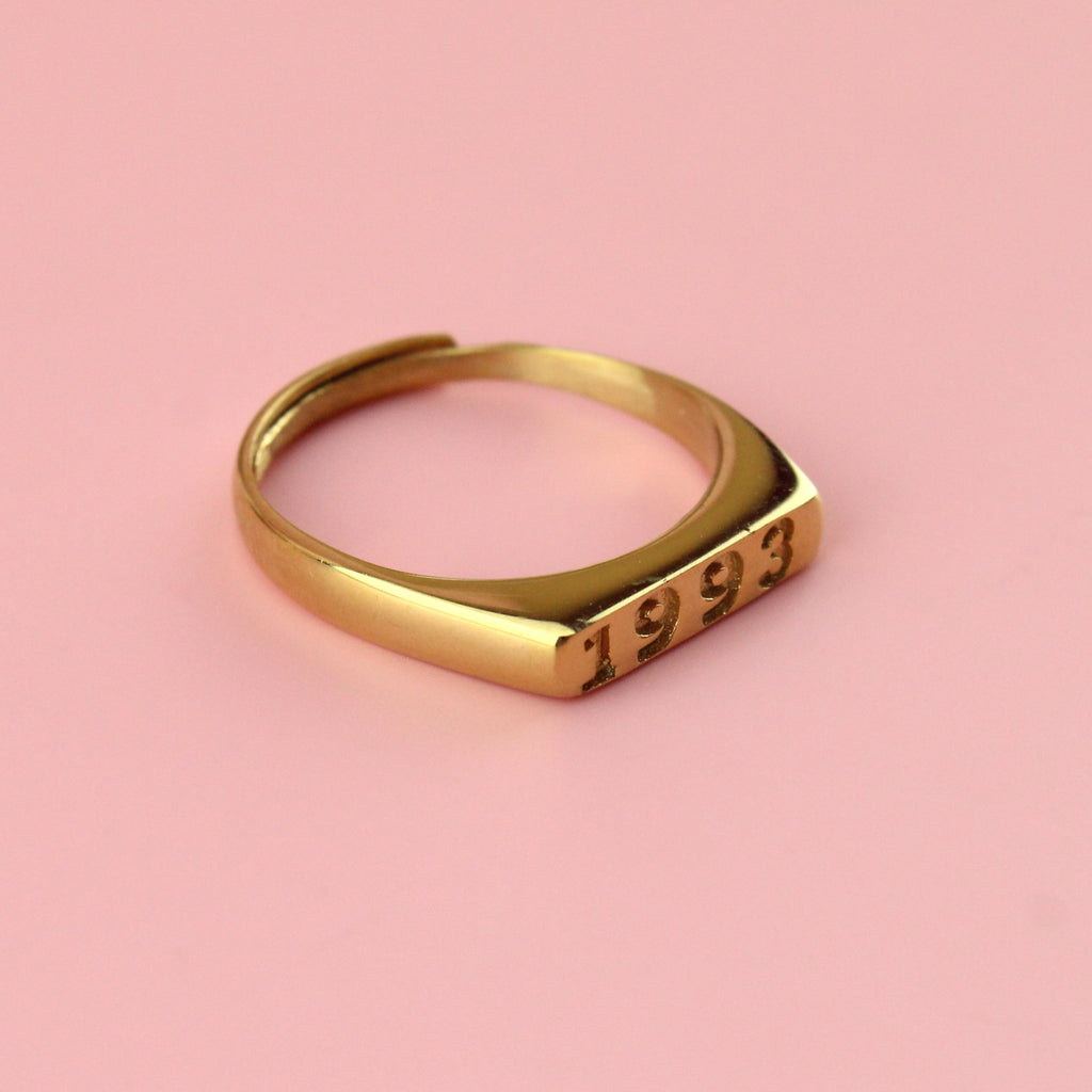Gold plated stainless steel ring with 1993 engraved on the front