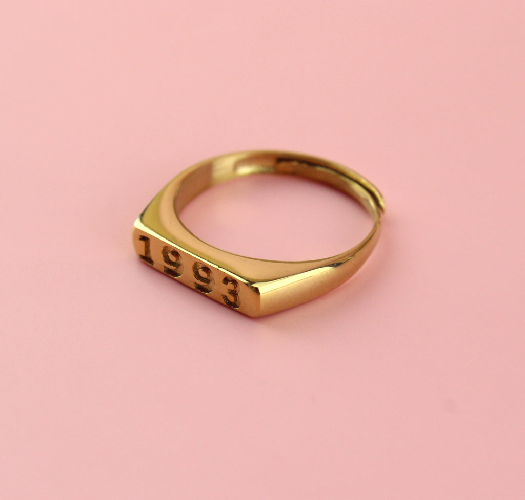 Gold plated stainless steel ring with 1993 engraved on the front