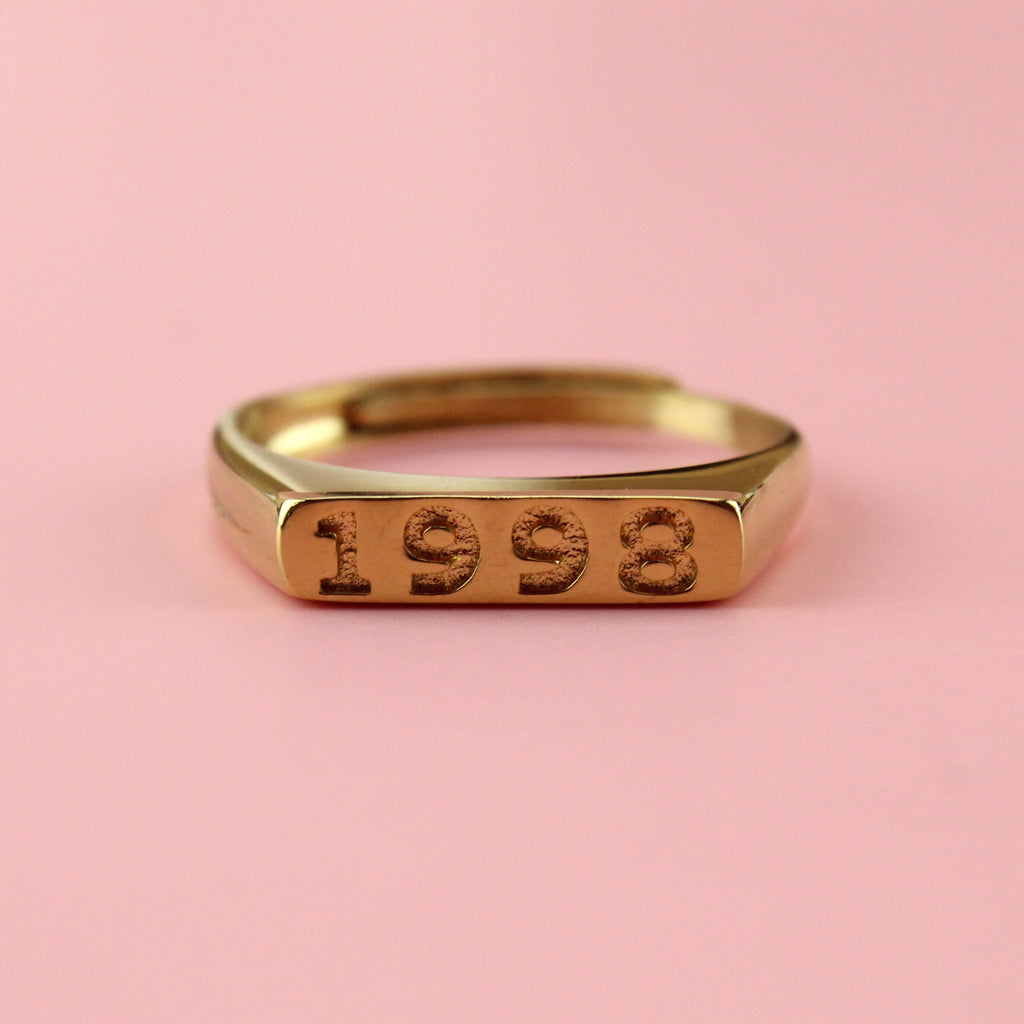 Gold plated stainless steel ring with 1998 engraved on the front