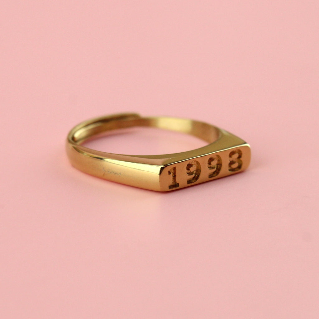 Gold plated stainless steel ring with 1998 engraved on the front
