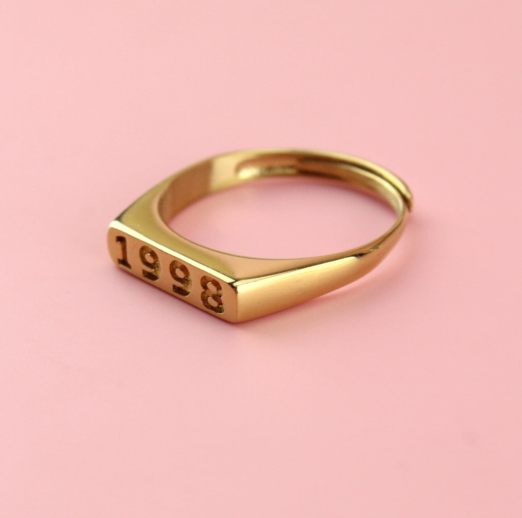 Gold plated stainless steel ring with 1998 engraved on the front