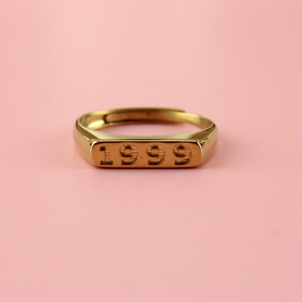 Gold plated stainless steel ring with 1999 engraved on the front