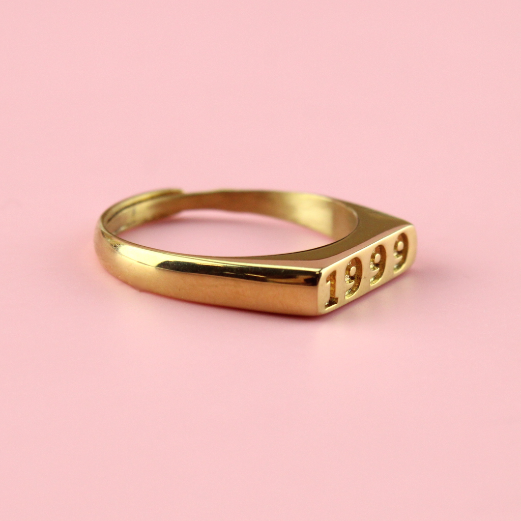Gold plated stainless steel ring with 1999 engraved on the front