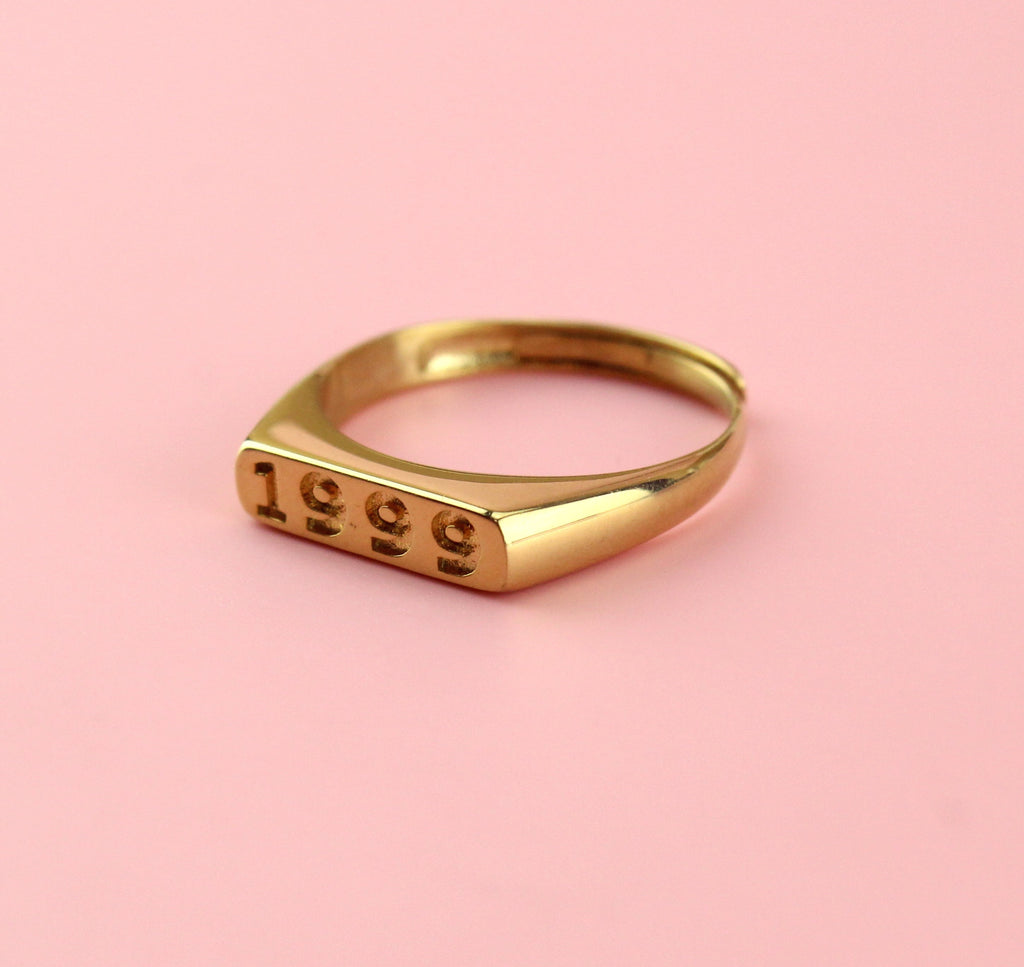 Gold plated stainless steel ring with 1999 engraved on the front