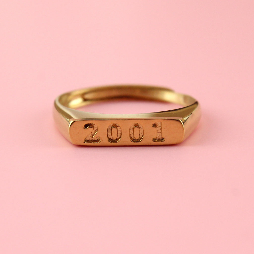 Gold plated stainless steel ring with 2001 engraved on the front