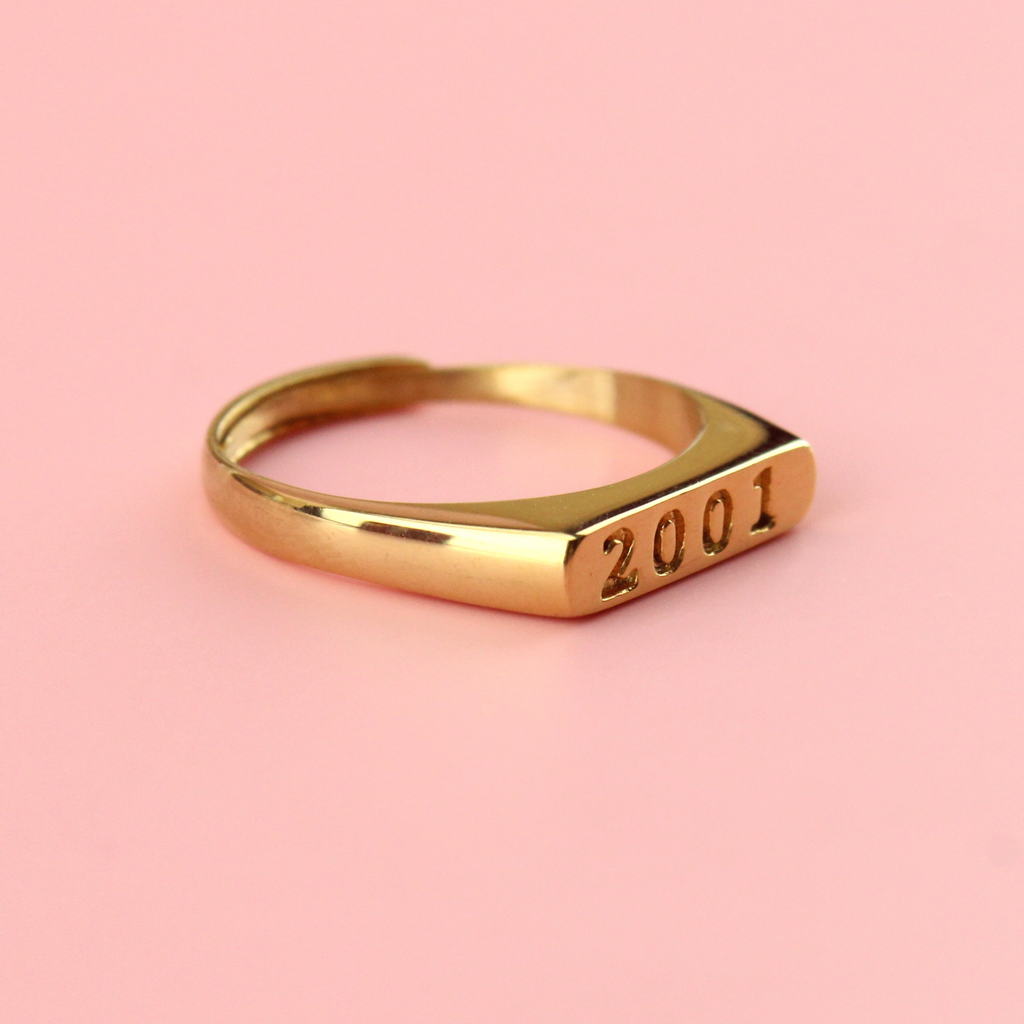 Gold plated stainless steel ring with 2001 engraved on the front