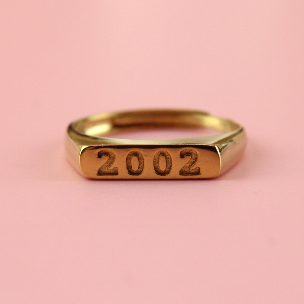 Gold plated stainless steel ring with 2003 engraved on the front