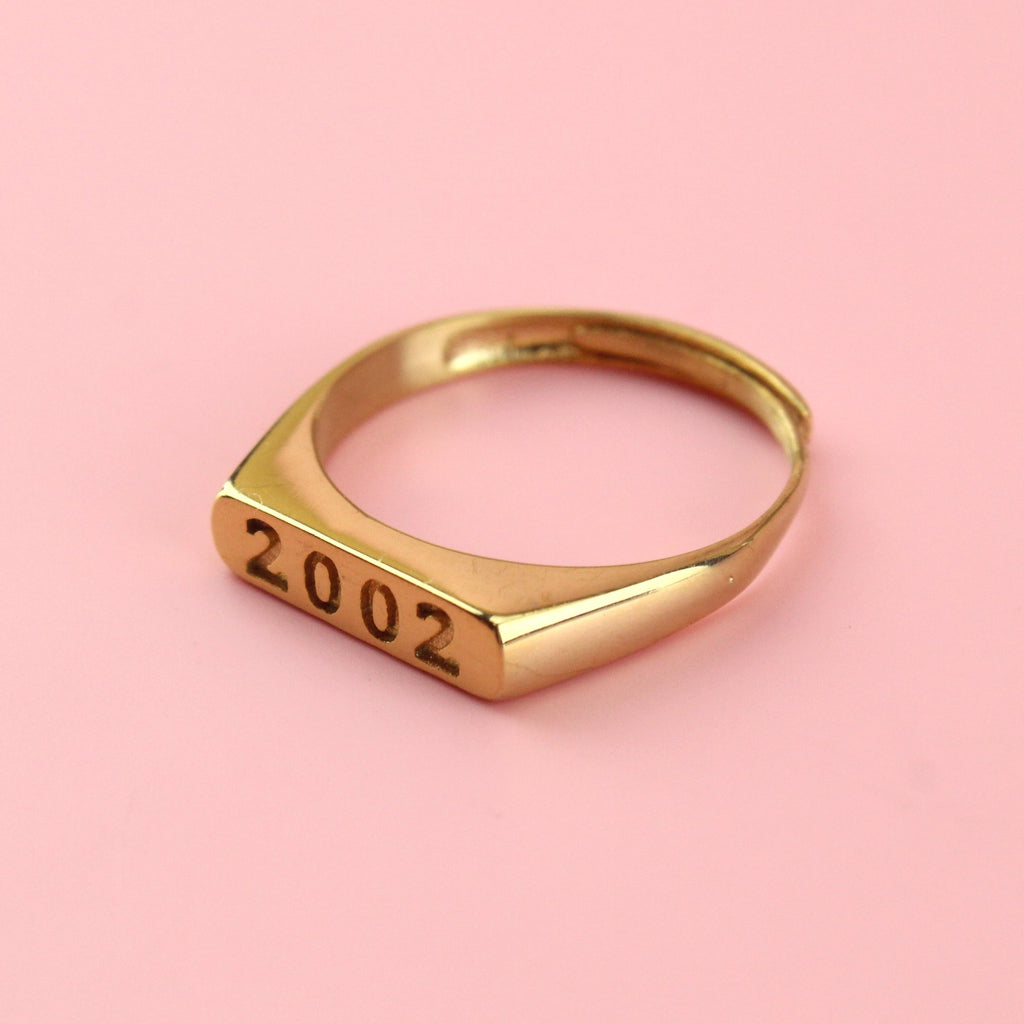 Gold plated stainless steel ring with 2003 engraved on the front