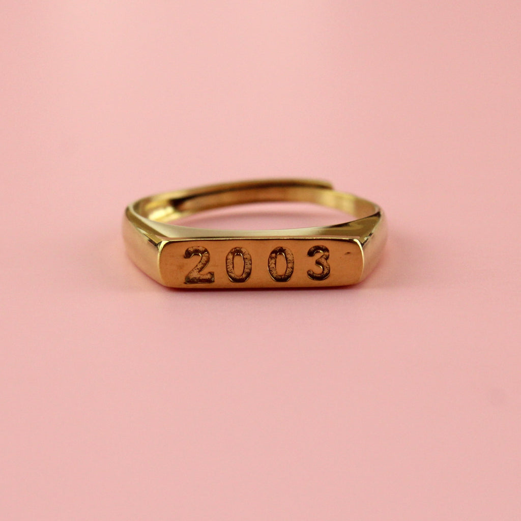 Gold plated stainless steel ring with 2003 engraved on the front