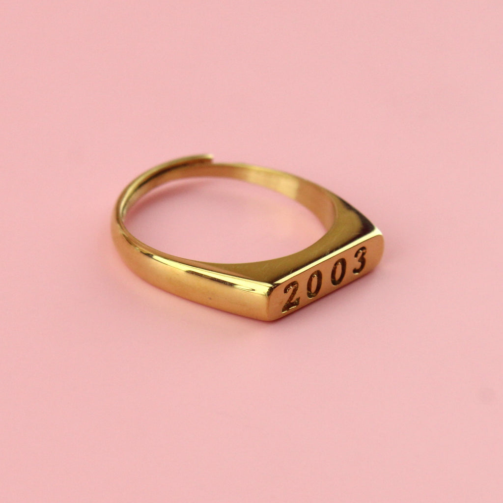Gold plated stainless steel ring with 2003 engraved on the front