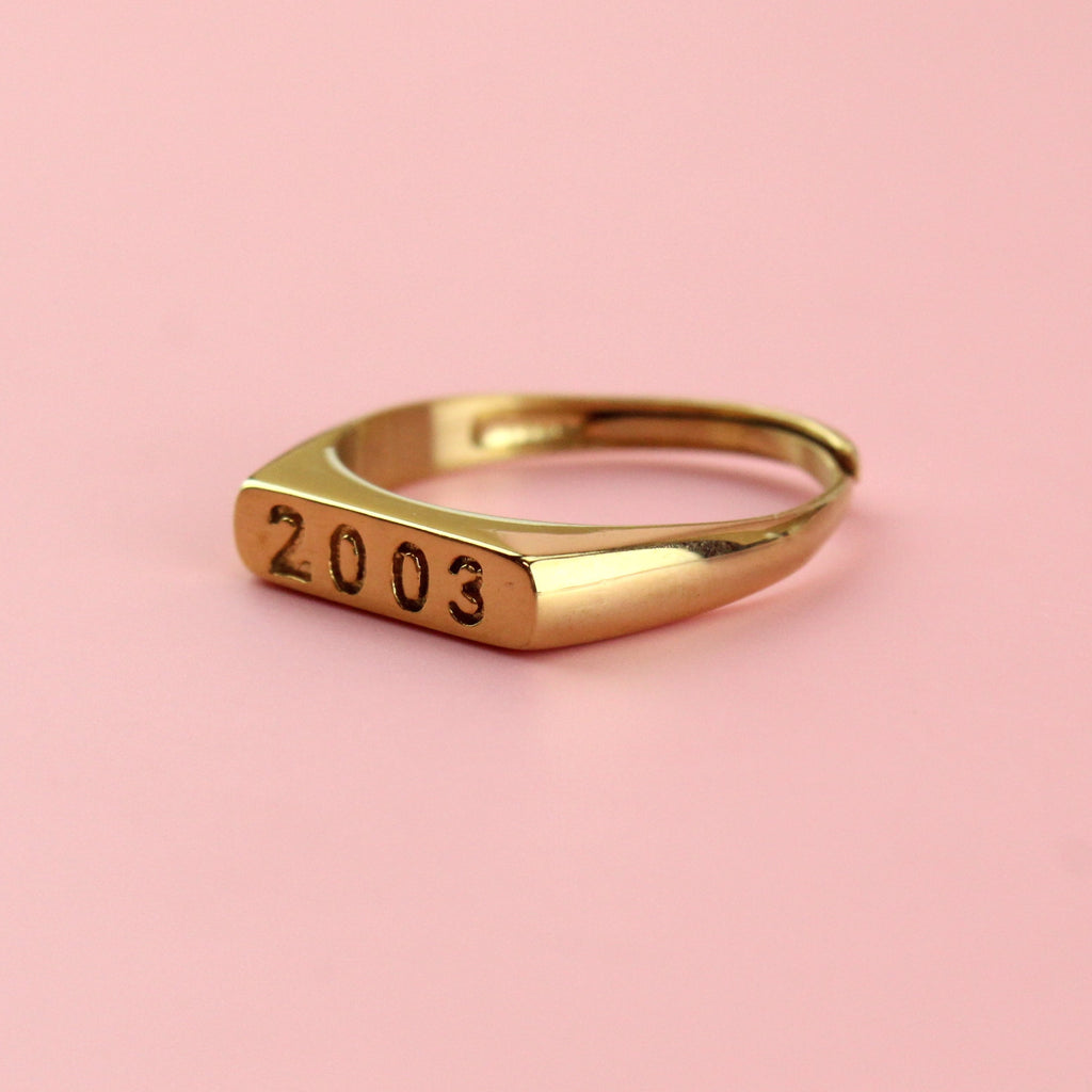 Gold plated stainless steel ring with 2003 engraved on the front